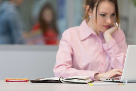 Cute female Businessperson thinking and looking into Computerの写真素材