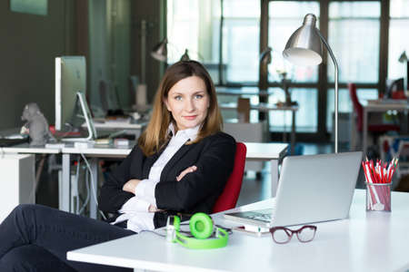 Charismatic Business Lady in official clothing in contemporary Office Interiorの写真素材