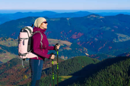 Woman hiker on a mountain viewing the sceneryの写真素材