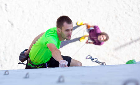Athlete on climbing Wall and belaying referee watching himのeditorial素材