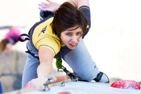 Cute female Athlete hanging on climbing Wallのeditorial素材