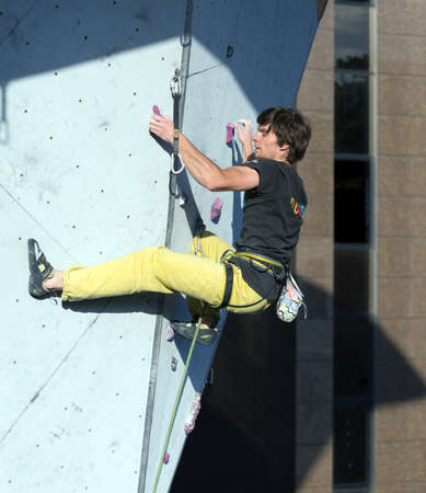 Climber hanging on climbing Wall at Competitionsのeditorial素材