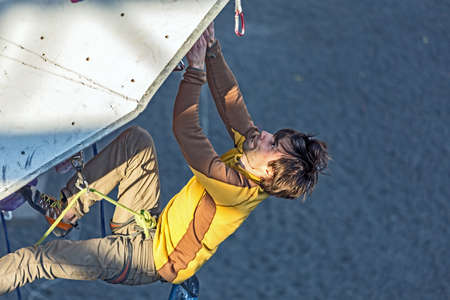 Climber hanging on climbing Wall at Competitionsのeditorial素材