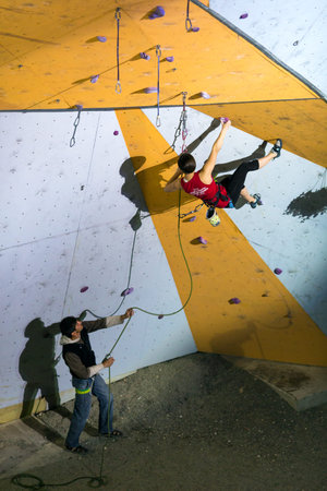 Elegant female Climber moving up on climbing wallのeditorial素材