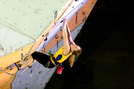 Climber hanging on Climbing Wallのeditorial素材
