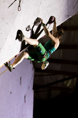 Female Climber on Overhanging Roof in night illuminationの写真素材