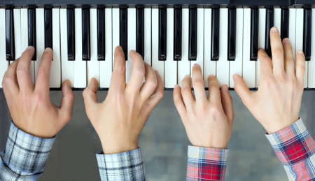 Piano Keyboard top View Hands of Man and Woman playingの写真素材