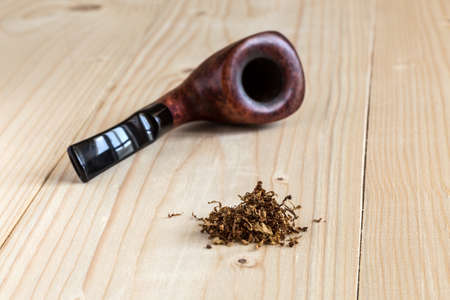 Dose of dry Tobacco and Pipe on wooden Backgroundの写真素材