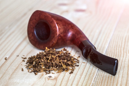 Dose of dry Tobacco and Pipe on wooden Backgroundの写真素材