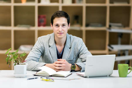 Portrait of Young corporate Trainee at cozy working Placeの写真素材
