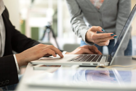 Male and Female Businesspeople discussing Project at Computerの写真素材