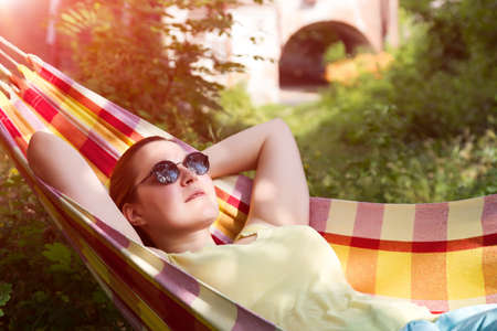 Person in sunglasses relaxing in Hummock at Summer Gardenの写真素材