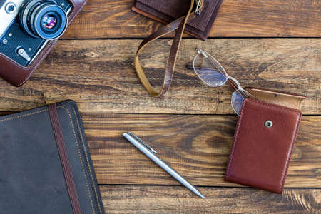 Leather vintage Items and Photo camera on Wood Backgroundの写真素材