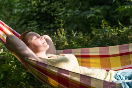 Person relaxing in Hummock at Summer Garden side Viewの写真素材