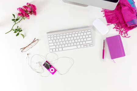Workplace Top View with red and purple Items on White Deskの写真素材