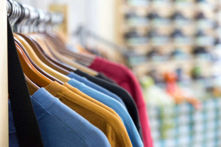 Row of Summer Seasonal Apparel on Hangers of Retail Shopの写真素材