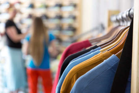Row of Summer Seasonal Apparel and Customers in Retail Shopの写真素材