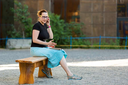 Casual dressed Woman talking over Telephoneの写真素材