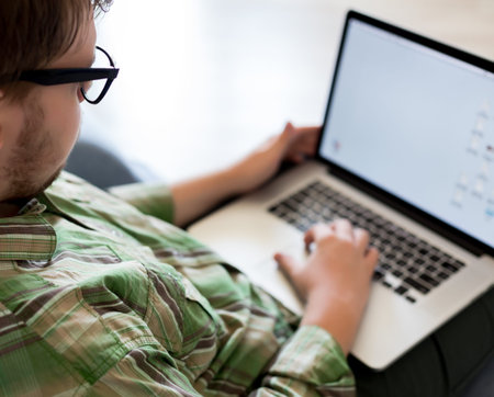 Young Man working on portable Computer