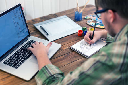 Artist drawing Sketch on Paper at cozy studioの写真素材