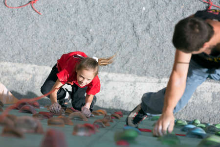 Father teaching his little baby daughter rock climbingのeditorial素材