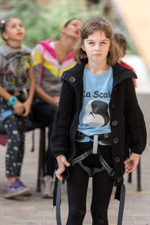 Little rock climber in safety harnessのeditorial素材