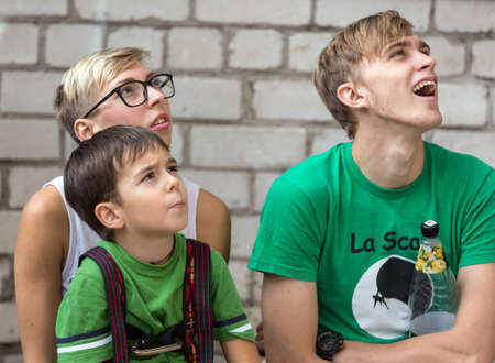 Family of three people watching performance of rock climbersのeditorial素材