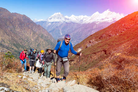 Group of Mountain Climbers walking up on Mountain Trail Sunnyの写真素材