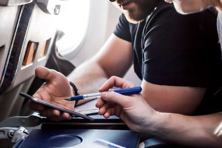 Man and Woman using modern Telephone in the Aircraftの写真素材