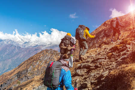Group of People walking up on Mountain Trail with Sunの写真素材