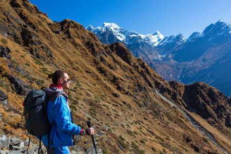 Man staying on Mountain Slope and admiring the Viewの写真素材