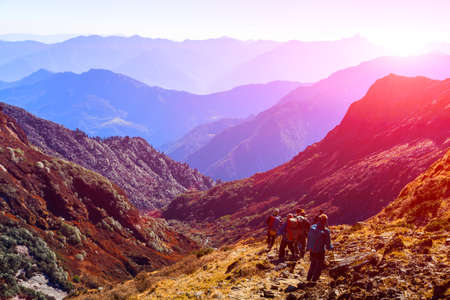 Group of People with Backpacks walking on Trail sunny and saturatedの写真素材