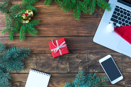 Wooden Table top View with blank Notepad and Christmas Giftの写真素材
