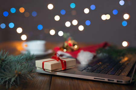 Greetings throw Internet Gift Box Computer and Christmas Lightsの写真素材