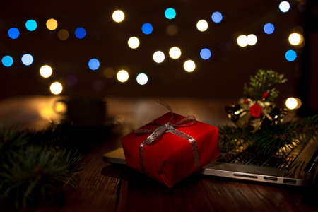Greetings throw Internet Gift Box Computer and Christmas Lights darkの写真素材