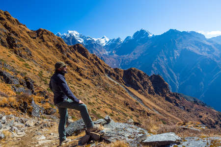 Sportive Man in Travel Hat observing Mountain Landscapeの写真素材