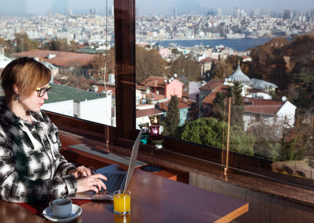 Business Woman working on portable Computer at roof top cafeの写真素材