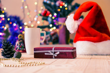 New Year gift and Santa Hat on wooden floorの写真素材