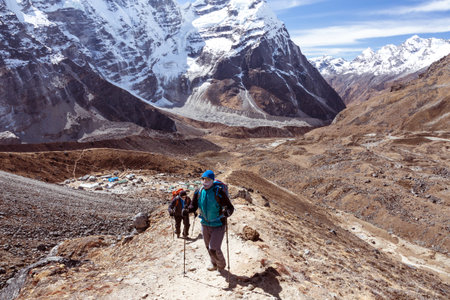 Mountain Climbers Team walking up on rocky Footpathの写真素材