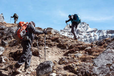 Mountain Climbers Team walking up on rocky Footpathの写真素材