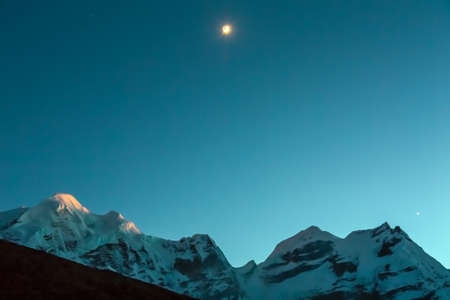 Evening Mountain View with Sunset and Moonriseの写真素材