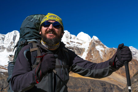 Portrait of mature bearded smiling alpine Climber in Mountainsの写真素材