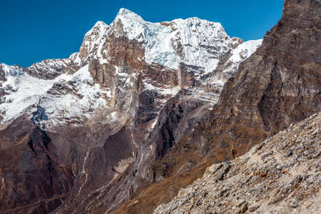 Iconic View of high Mountains and Person staying on rocky Cliffの写真素材