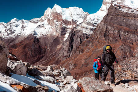 Hikers walking on Mountain Terrain on popular trekking Routeの写真素材