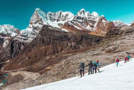 Group of Athletes of different Age crossing Glacier in high Mountainsの写真素材