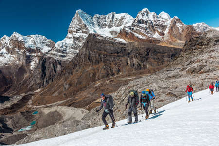 Group of People of different Age crossing Glacier in high Mountainsの写真素材