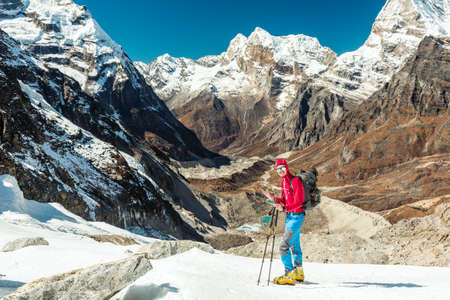 Mountain Climber using Cell Phone at high Altitude extreme Conditionsの写真素材