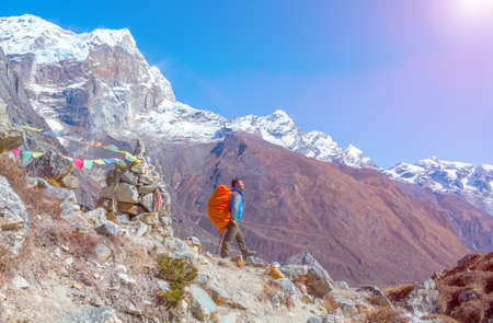 Sunny Mountain View and Nepalese Mountain Guide staying on Footpathの写真素材