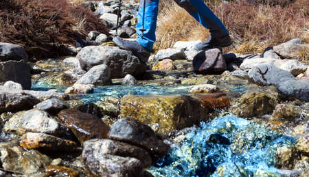 Small Mountain Creek and Hiker crossing itの写真素材