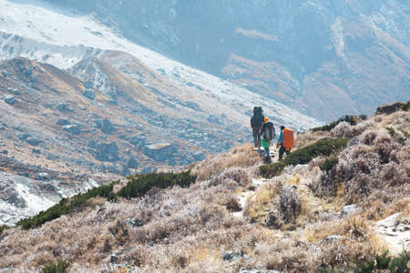 Mountain Slope and Group of Climbers walking on Footpathの写真素材